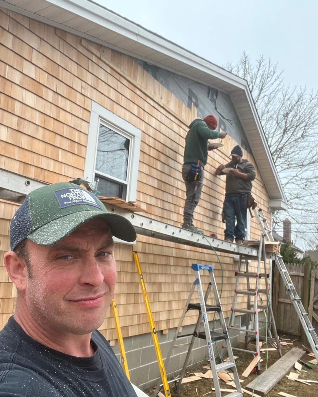 The CB Builders Corp. crew installing cedar shingle siding on a South Shore home