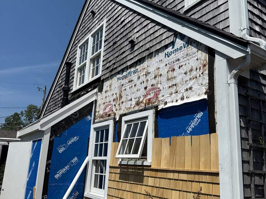 South Shore home stripped to housewrap and flashing during a cedar shingle siding replacement by CB Builders Corp.