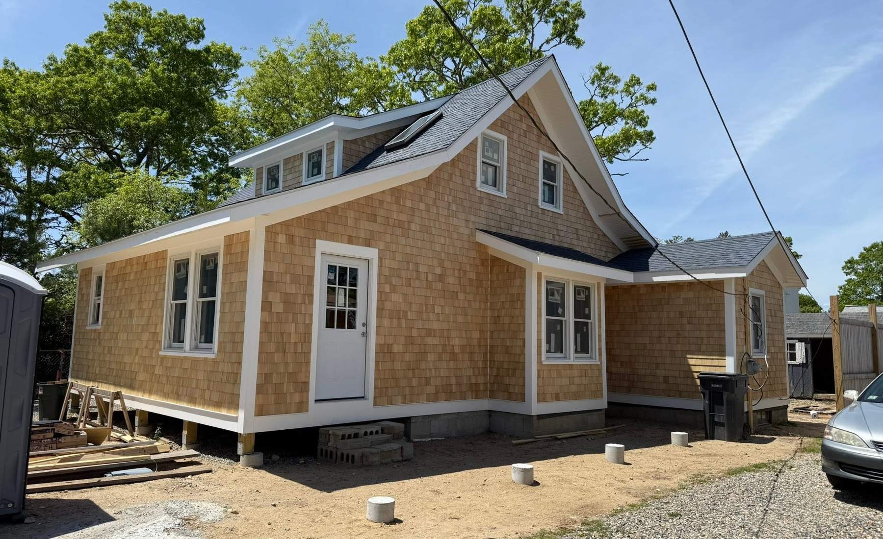Completed cedar shingle exterior renovation with a new roof, trim, and windows on a South Shore home by CB Builders Corp.